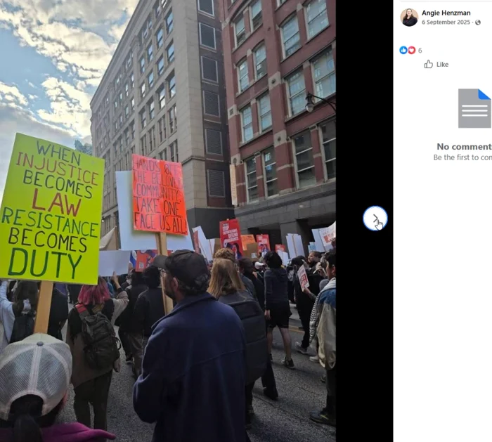 A crowd stands on a city street beside tall brick buildings, holding multiple protest placards. A Facebook post header at right displays Angie Henzman and the date 6 September 2025.