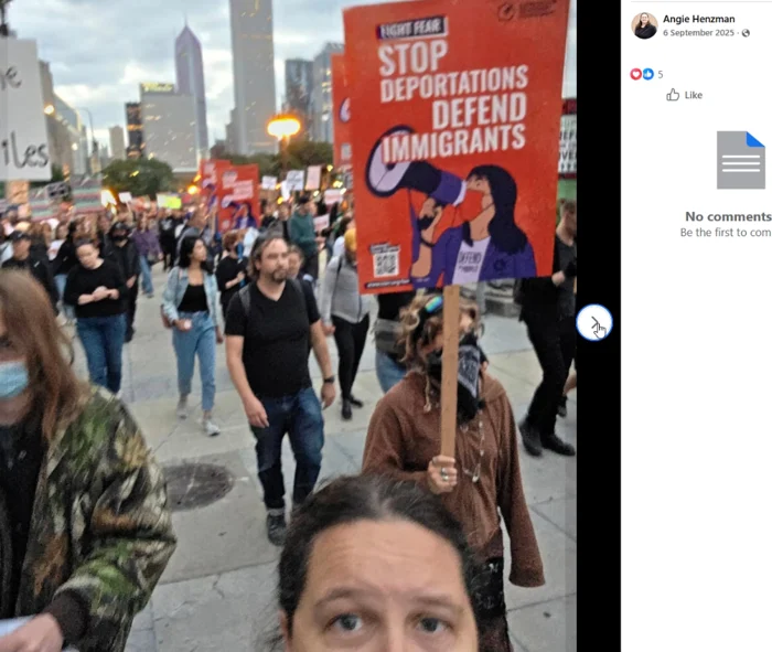 A street-march crowd is shown with a large red placard reading "STOP DEPORTATIONS DEFEND IMMIGRANTS."