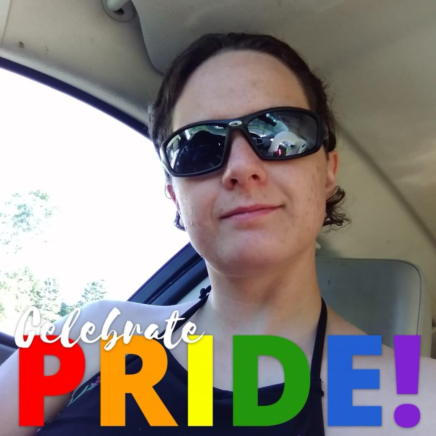 A supplied portrait photo taken inside a vehicle with a large rainbow-colored Celebrate PRIDE! overlay across the bottom.