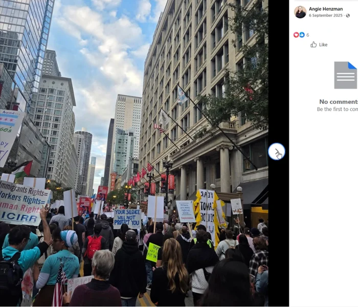 A dense crowd holds immigrant-rights placards in a downtown street, with a Chicago Theatre marquee visible.